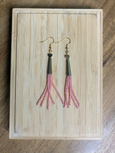 Load image into Gallery viewer, Countertop view of petite gold heart earrings with five dangling strands of pink beads.
